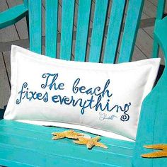 a pillow that says the beach fixes everything sitting on top of a blue chair