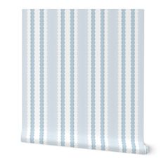 a white and blue striped wallpaper with dots