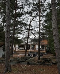 the house is surrounded by trees and rocks