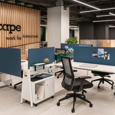 an office with three desks and two chairs in front of the wall that says inscape