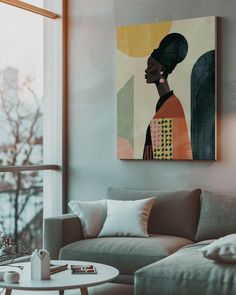 a living room filled with furniture and a painting on the wall above it's windows