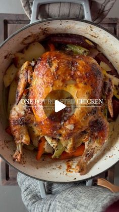 a person holding a pan filled with chicken and vegetables