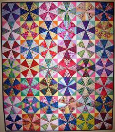 a colorful quilt hanging on the wall