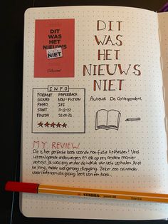 an open notebook with writing on it and a red pen next to the page that says dit was he neu's nift