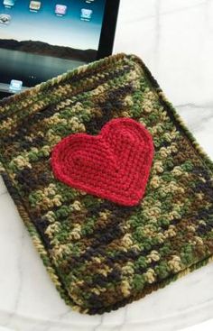 an ipad case with a crocheted heart on it