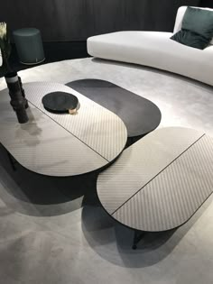 two tables sitting on top of each other in front of a couch and coffee table