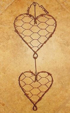 two hearts shaped like barbed wire with the word love written on them in cursive writing