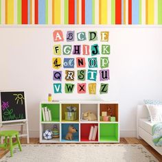 a child's room with colorful striped wallpaper