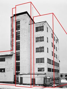 an old building with red lines in front of it