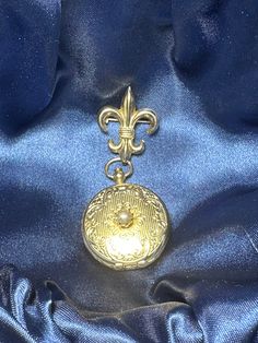 This vintage locket from Coro is a unique find for any jewelry collector. The locket features a beautiful fleur de lis design and can hold two pictures. This piece is signed and dates back to the 1940s. It would make a great addition to any vintage or antique jewelry collection. The locket is in good condition and shows minimal signs of wear. Perfect for gifting or adding to your personal collection. FYI: We have been in pastoral ministry for over 40 years, the goal of selling any items on 'powers-gems' is to support children's ministries in Honduras and other nations where children are being taken from living in the city garbage dumps, educated, feed and clothed by Godly people to give them a future with hope and purpose. Join us:) Vintage Medallion Locket Jewelry, Antique Charms Locket Necklace For Keepsake, Vintage Formal Jewelry With Charms, Vintage Locket Necklace With Charms As Collectible, Vintage Locket Necklace With Charms For Collectors, Vintage Medallion Brooch Jewelry, Ornate Antique Gold Locket Necklace Collectible, Antique Gold Medallion Locket Necklace Vintage Style, Vintage Antique Gold Medallion Locket Necklace