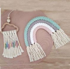 three pieces of macrame with tassels hanging from them on a table