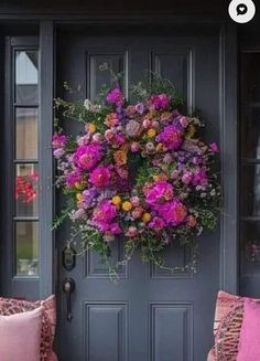 the front door is decorated with pink and purple flowers