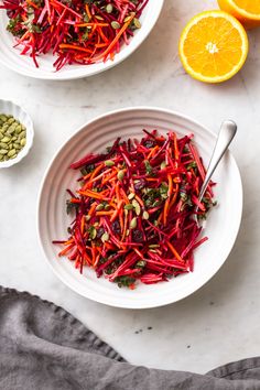 two white bowls filled with carrots, beets and pistachio sprouts