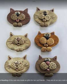 there are six cat magnets on the table together, each with different faces and eyes