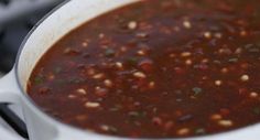 a pot filled with chili and beans on top of a stove