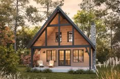 a small cabin style house in the middle of a field with trees and grass around it