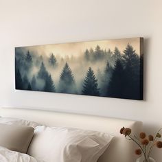 a painting hanging on the wall above a bed with white sheets and pillows in front of it