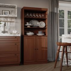 a wooden cabinet with dishes and glasses on it next to a bar stool in front of a window