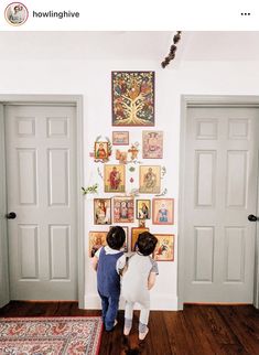 two children looking at pictures on the wall