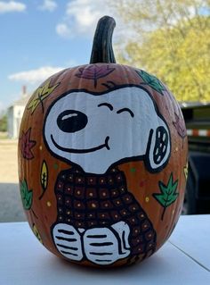 a painted pumpkin with a dog on it