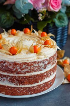 a close up of a cake on a plate with flowers and leaves in the background