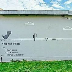 an advertisement on the side of a building that says, you are offline don't panic look around interact with reality