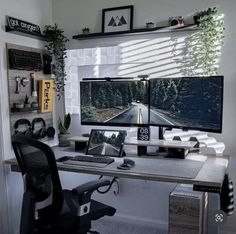 two computer monitors sitting on top of a desk