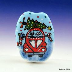 a glass figurine with a cat driving a bus and christmas tree on top