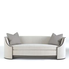 a white couch with two pillows on it's back and the seat upholstered