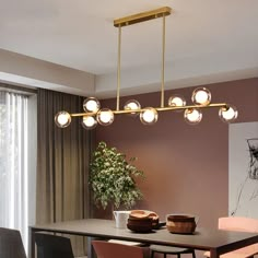 a dining room table and chairs with lights hanging from it's ceiling above them