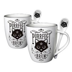 two coffee mugs with spoons in the shape of cats