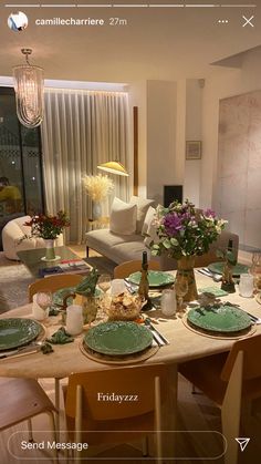 a dining room table set with green plates and place settings