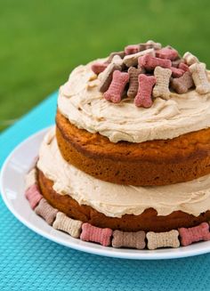 a cake with white frosting and pink and brown marshmallows on top