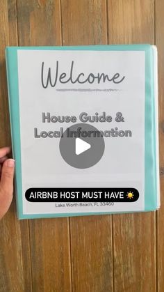 a person holding up a sign that says welcome to the house guide and local information