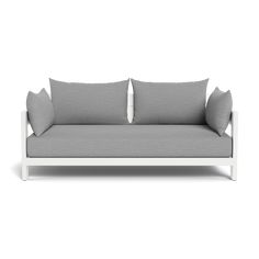 a gray couch with two pillows on it's back and one arm facing the camera