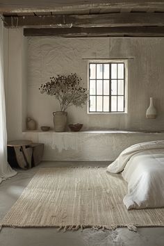 a bedroom with white walls and carpeted flooring