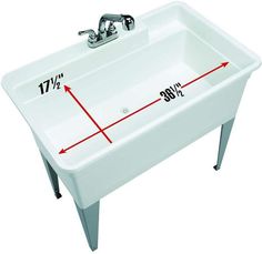 a white sink with measurements on it