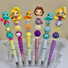 there are many different pens in the holder on the table with each one's own character