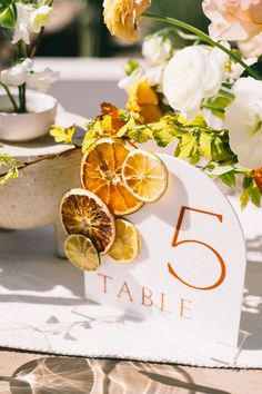 the table numbers are displayed with lemons and flowers