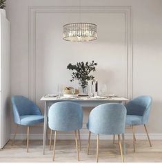 a dining room table with blue chairs and a chandelier