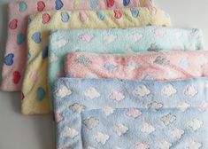 four baby blankets with hearts on them