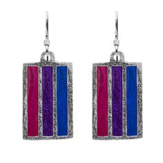 Badali Jewelry's artist Hillarie Gowers created our Bisexual PRIDE flag earrings. The charms are hand enameled with the pink, purple, and blue colors of Bisexual Pride. 5% of all pride jewelry sales will be donated to a local LGBTQ+ charity. Details: The Bisexual Pride Earrings are sterling silver and are a dangle style. The flag charms measures 28 mm long, 15.6 mm wide, and 1.3 mm thick and weighs 4.3 grams each. The backs of the charms are textured and stamped with our makers mark, copyright, Flag Earrings, Pride Jewelry, Lgbtqia Pride, Bisexual Pride Flag, Pride Jewellery, Retail Jewelry, Pride Flag, Pride Flags, Artistic Jewelry