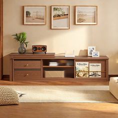 a living room with some pictures on the wall and a couch in front of it