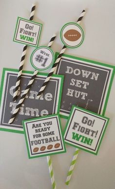 four football themed straw toppers and two drinking straws on a table with paper straws