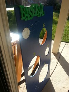 there is a sign that says baseball in front of a door with holes on it