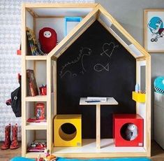 a child's play house made out of wood and painted with chalkboard on the wall