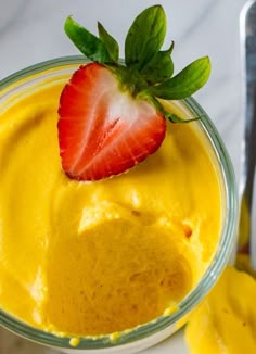 a close up of a bowl of food with a strawberry on top