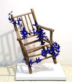 a wooden rocking chair with blue flowers on it