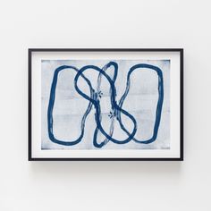 a blue and white painting hanging on the wall