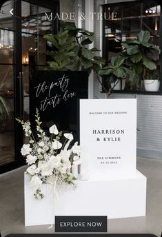 the wedding sign and flowers are on display in front of the store's entrance